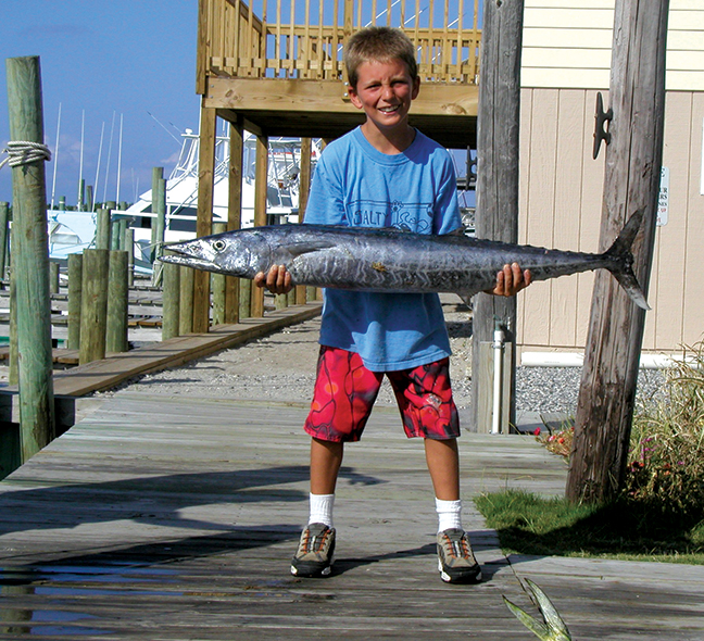 Boy holding fish caught on the Albatross Fleet