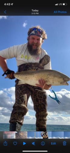Jordan Martin with one of four drum he caught on Wed The fish were driving the bait fish to the beach.